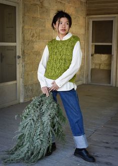 a woman holding a christmas tree in her hands