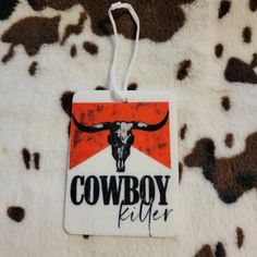 a cow skull is hanging on the back of a white and brown animal print blanket