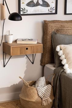 a bed room with a neatly made bed and two pictures on the wall above it