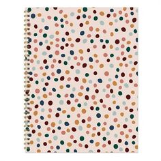 a spiral notebook with multicolored polka dots on the front and back cover,