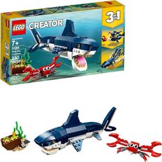 two legos are shown in front of the box and one has an image of a shark