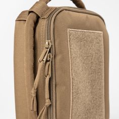 the back side of a tan bag with zippers