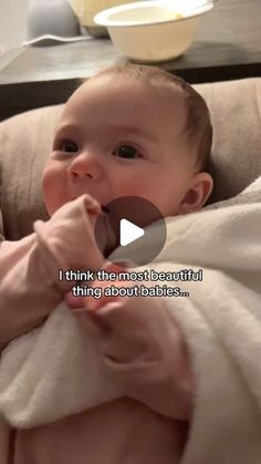 a baby wrapped in a blanket is being held up by someone's hand and the caption reads, i think the mom beautiful thing about babies