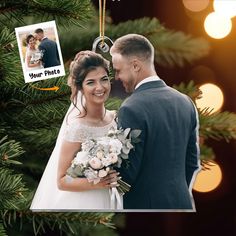 an ornament hanging from a christmas tree with a photo of a bride and groom