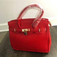 New Red Leather Women Handbag Never Used Luxury Red Bag With Hasp Closure, Red Shoulder Box Bag For Office, Red Tote Box Bag For Office, Trendy Red Box Bag With Double Handle, Red Satchel Box Bag For Office, Red Box Bag With Detachable Strap And Double Handle, Luxury Red Office Bags, Red Leather Bag With Branded Hardware, Red Top Handle Box Bag For Office