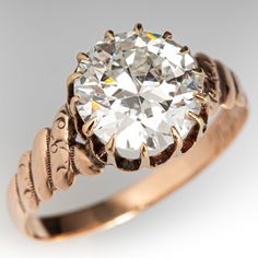 an antique diamond ring is shown on a white background, with the center stone surrounded by filigrees