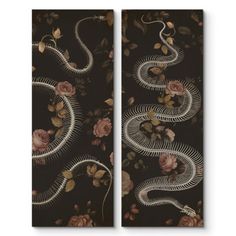 two black wall hangings with flowers and snakes on them, one in the shape of a snake