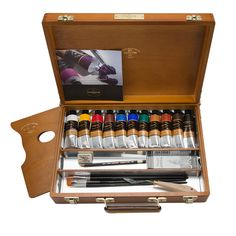 an open wooden box with paint and brushes in it