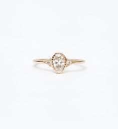 a yellow gold engagement ring with an oval cut diamond