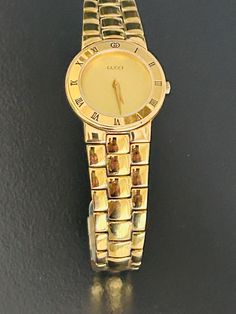 Gucci beautiful women's  6 1/2"  gold link timepiece, Swiss made and pre-owned with a new battery, gives precise time, with a wonderful new crystal, and recently serviced by a professional  jeweler. Serial number 0164719 embossed @ back base and 100% authentic guaranteed. with light scratches @ bezel, link bracelet and back base. and a butterfly secure clasp. and light aging @ back base. Model 33002l  and a 25mm case (the dial is the size of a nickel) Please view my 100% positive reviews it tells my history. with same day secure, fast shipping, Thank you for your consideration. Base Model, Gold Link, Swiss Made, Link Bracelets, Time Piece, Womens Watches, Wrist Watch, Jewelry Watches, Gucci