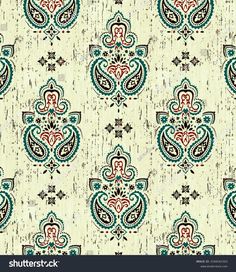 an ornate paisley pattern with blue, red and green colors on a beige background stock photo