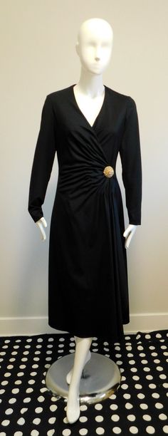 Black matte jersey lined wrap dress Long sleeves Secured with hook, tie and snap Embellished with a sewn on gold tone brooch with rhinestones  Labeled - Majestic  100% Polyester  Union Label  Please scroll through photos for measurements Elegant Party Dresses With Gold Buttons, Elegant Evening Dresses With Gold Buttons, Formal Fitted Dress With Gold Buttons, Fitted Evening Dress With Gold Buttons, Wrap Dress Long Sleeve, Wrap Dress Long, Velvet Coat, Dress Long Sleeves, Gorgeous Fabrics