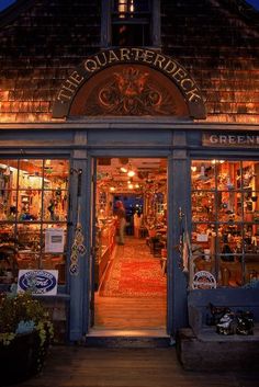 the entrance to an antique store at night