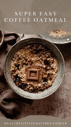 a bowl filled with oatmeal next to two spoons on top of a table