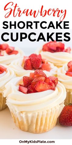 strawberry shortcake cupcakes with white frosting and fresh strawberries on top