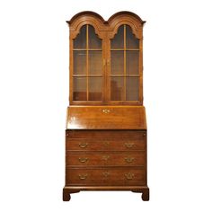 an old wooden dresser with glass doors and drawers