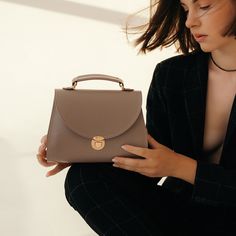 In a world of constantly changing trends and fashion, the "Taistra" messenger bag for women always remains a faithful symbol of your elegance and taste. Dimensions: 9,1х5,5х3,2 in / 23x14x8 cm. Material: genuine leather. Colors: black, brown (tobacco), gray (French grey). Includes a detachable and adjustable shoulder strap. Trendy Office Satchel In Clutch Shape, Trendy Handheld Flap Bag For Travel, Trendy Satchel Saddle Bag For Daily Use, Trendy Handheld Flap Bag For Everyday, Handheld Flap Bag For Daily Use, Handheld Saddle Bag For Everyday Use, Trendy Top Handle Flap Bag For Gift, Trendy Top Handle Flap Bag As Gift, Trendy Top Handle Saddle Bag For Travel