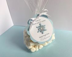 a small bag filled with marshmallows on top of a blue tablecloth