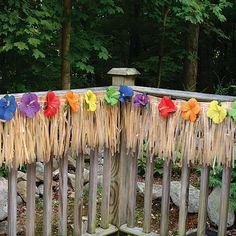 a wooden fence with some flowers on it