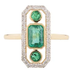 This modern antique ring features a captivating three-stone emerald axis design, elegantly set in 18k yellow gold. The vibrant emeralds are flanked by sparkling diamonds, creating a striking contrast. The intricate detailing and timeless appeal of the gold setting make this ring a perfect blend of contemporary style and vintage charm. Emerald enhances intellectual capacity of the person.  Designed with three stone emerald set with diamonds that makes it a perfect fit to wear it on your wedding or style it with any of your basic outfit to give it a glam. This is a perfect Emerald Ring. This is a perfect May Birthstone Jewelry also perfect Grandma Gift, Valentine Gift, Gift For Mom, Wedding Gift, Engagement Gift, Mother Daughter Gift, Bride To Be Gift, Bridesmaid Gift, Gift for Wife, Mom Gif Luxury Three-stone Green Diamond Ring, Luxury Green Diamond Three Stone Ring, Luxury Green Three Stone Diamond Ring, Luxury Green Three-stone Diamond Ring, Art Deco Green Diamond Ring In 14k Gold, Emerald Set, Mom Wedding Gift, Mother Daughter Gifts, Mom Wedding