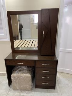 a bedroom with a dresser and mirror in it