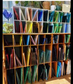 the shelves are filled with many different colored papers