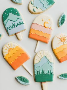 some cookies that are shaped like mountains and trees with the letter c on them, sitting next to each other