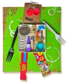 an assortment of crafting supplies are displayed on a piece of green paper with scissors and other items