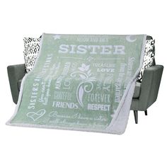 a blanket that is sitting on top of a chair in front of a gray couch