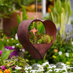 a heart shaped hanging planter filled with flowers