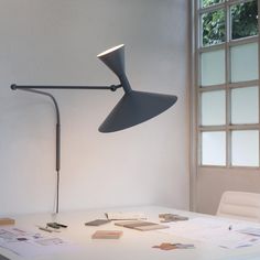 a desk lamp sitting on top of a white table