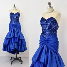 a blue dress on a mannequin with sequins and ruffles