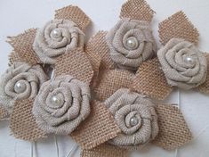 six burlap flowers with pearls on them