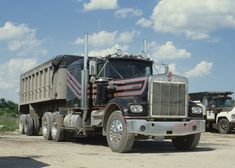 a large truck is parked in the dirt