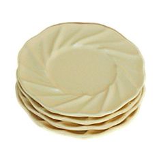 four white plates stacked on top of each other