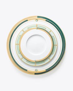 three green and gold plates stacked on top of each other in the shape of circles