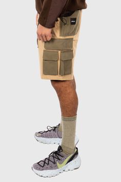 Official presents the Nexus Ripstop Cargo Shorts (Khaki) Features: Multi-pocket ripstop cotton cargo shorts Built-in webbed belt waistband adjuster Stretchy waistband Ripstop cotton and nylon construction Front and side of leg cargo pockets with hidden magnetic buttons Contrast nylon pocket on front of leg Small key zipper pocket on left side Small D-ring attachment under back side of waist Urban Outdoor Shorts With Side Pockets, Urban Style Shorts With Side Pockets For Outdoor, Urban Shorts With Side Pockets For Outdoor, Khaki Cargo Pants For Outdoor Activities, Khaki Techwear Shorts For Streetwear, Techwear Cargo Shorts With Pockets For Hiking, Urban Style Cargo Shorts For Outdoor, Khaki Short Cargo Pants For Streetwear, Short Khaki Cargo Pants For Streetwear