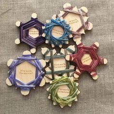 four different colored wooden ornaments with words on them