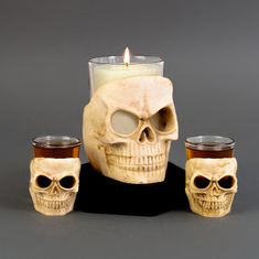 there is a candle and some skulls on the table