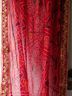 Very beautiful and gorgeous light weight red Georgette tie dye bandhej chunri with zari work. It is decorated with golden flower embroidered lace on all 4 sides. This is a ready to wear dupatta/scarf. It can be used for wedding, wedding rituals, party, bridesmaid gift, lehenga dupatta, Indian functions or events. Dimension: Length: 2 meter Width: 1.2 meter Rajasthani Dupatta, Golden Dupatta, Shoulder Scarf, Lehenga Dupatta, Embroidery Border, Modern Christmas Decor, Indian Bridal Wear, Wedding Rituals, Golden Flower