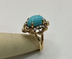 Welcome To Gold Knox This is stunning 14k yellow gold ring with natural untreated turquoise cabochon satin four prong setting surrounded by small diamonds!! The turquoise cabochon has a high dome with intense color across. This is a very unique piece and would be a great gift for special occasion. Details below: Material 14k yellow gold, natural green turquoise, diamond Ring Size 7 US Turquoise 18mm X 8mm (4mm high) Diamond 16 1.5mm Weight 6.3 gm Please, be sure to view the pictures carefully as Luxury Yellow Gold Turquoise Ring Oval Cabochon, Elegant Gold Turquoise Cabochon Ring, 14k Yellow Gold Turquoise Cabochon Ring, Turquoise Diamond Ring, Luxury Gold Cabochon Turquoise Ring, Light Blue Gemstone, Luxury Yellow Gold Turquoise Ring, Oval Cabochon, Statement Rings Diamond, Yellow Gold Ring