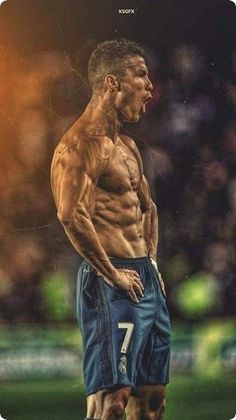 a man standing on top of a soccer field with his hands in his pockets and no shirt