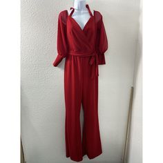 Elevate Your Wardrobe With This Stunning Fashion Nova Jumpsuit In A Beautiful Red Color. The Wide-Leg Design And Belted Waist Make It A Perfect Choice For Any Occasion, Whether It's A Party Or A Casual Day Out. The Jumpsuit Is Made Of A Comfortable And Breathable Blend Of Polyester And Spandex, Which Ensures A Perfect Fit For Any Season. The Jumpsuit Features A V-Neckline, Long Sleeves, And A Pullover Closure. The Lace Accents And Slight Stretch Add A Touch Of Elegance And Style To The Overall L Red Party Jumpsuits And Rompers, Red Jumpsuits And Rompers For Work In Fall, Red Jumpsuit For Workwear In Fall, Red Jumpsuit For Work In Fall, Red Solid Color Jumpsuits And Rompers For Spring, Red Fitted V-neck Jumpsuit, Red Stretch Jumpsuits And Rompers For Fall, Red Solid Color Jumpsuits And Rompers For Night Out, Red Solid Color Jumpsuit For Night Out