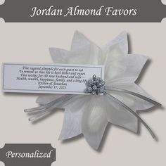 a white flower with a name tag attached to it's center and the words, jordan almondd favors