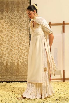 Ivory straight kurta with gota patti, dabka, zardozi embroidery on the bodice. Paired with a crushed skirt and dupatta with motif danglers. - Aza Fashions Elegant Off White Dupatta For Reception, Elegant Off-white Dupatta For Reception, Unstitched Cream Lehenga, Elegant Off White Dupatta In Traditional Drape, White Silk Lehenga For Designer Wear, Elegant Off White Traditional Dupatta, Formal Off White Sets With Traditional Drape, Formal Off White Set With Traditional Drape, Elegant Off White Silk Dupatta