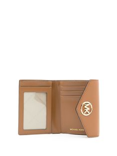 Brown Carmen monogram wallet from MICHAEL KORS featuring pebbled texture, monogram pattern, gold-tone logo plaque, foldover top with snap fastening, internal note compartments, rear zip pocket and internal slip pockets. | Michael Kors Carmen monogram wallet Gold Leather Wallet With Logo Plaque, Classic Business Wallets With Gold-tone Logo Plaque, Leather Wallets With Gold-tone Logo For Everyday Use, Classic Gold Wallet With Logo Plaque, Luxury Brown Wallet With Logo Plaque, Michael Kors Brown Leather Wallet, Michael Kors Brown Wallet With Interior Card Slots, Brown Michael Kors Wallet With Interior Card Slots, Classic Michael Kors Leather Wallet