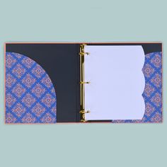 an open binder with blue and pink designs on it