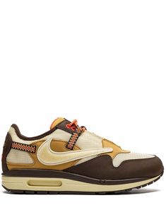 Brown leather x Travis Scott Air Max 1 low-top sneakers from NIKE featuring signature Swoosh logo detail, contrasting panel detail, round toe, front lace-up fastening, logo patch at the tongue, branded insole and rubber sole with Max Air cushioning. These styles are supplied by a premium sneaker marketplace. Stocking only the most sought-after footwear, they source and curate some of the most hard to find sneakers from around the world.. | Nike x Travis Scott Air Max 1 low-top sneakers Travis Scott Nike Air Max 1, Nike Travis Scott Air Force, Travis Scott Air Trainer, Travis Scott Jordan 1 Low Reverse Mocha, Dynamic Low-top Nike Air Max For Streetwear, Nike Tenis, Nike X Travis Scott, Nike T, Brown Sneakers