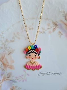 A beautiful handmade Frida patterned. It's displayed both sides. This is made with genuine Miyuki beads. It is high quality Japanese beads and brilliant colours and shape. It's came with a small gold colour chain.  The measurements; - Frida is 2.5cm. width from the top of the head and 4cm. height. - The necklace length is 55cm. (Without pendant)   This necklace will come with a small jewellery sheer drawstring pouch. Please feel free to contact me for the cost of delivery to everywhere else if outside Australia. Please note: product colour may slightly vary due to photographic lighting sources or your monitor settings.