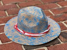 "Unique, one of a kind, hand painted, & designed straw fedora hat.  \"The Merica\" is designed with paint, Sari silk ribbons, & a large red safety pin.  She is patriotic & ready for the beach or poolside!  One size fits most - there is a ribbon in the band to adjust the sizing (circumference of band is 23 in.).  All sales final." Custom Hat Bands For Beach In Spring, Custom Fedora For Beach In Spring, Custom Beach Fedora For Spring, Unique Handmade Fedora For The Beach, Unique Handmade Fedora For Beach, Unique Handmade Hat Bands For Beach, Hand Painted Adjustable Fedora For Kentucky Derby, Custom Straw Hat With Curved Brim For Summer, Unique Summer Fedora With Curved Brim